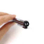 Rotring Tikky Graphic Fineliner with a cap labeled '0.5' held by a hand on a white background