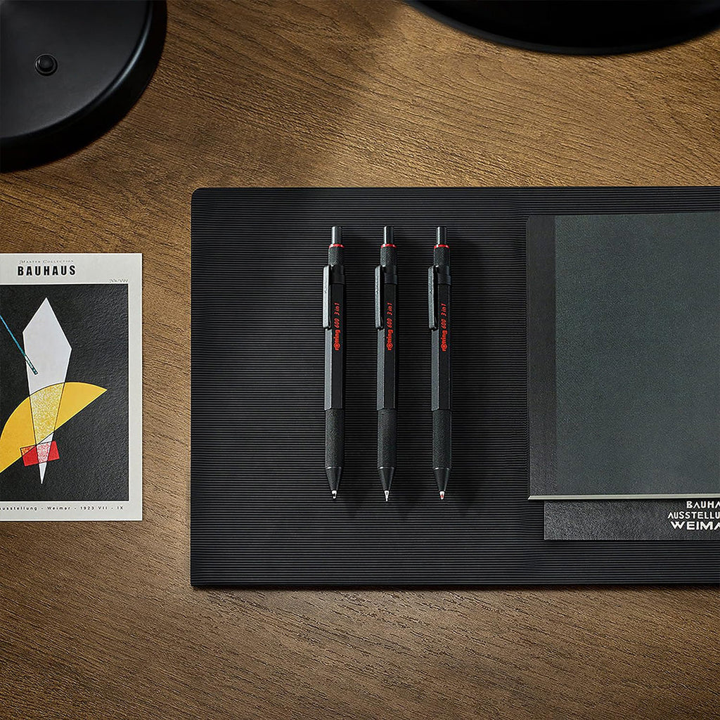 3 Rotring 600 3-in-1 Multi Pen and Mechanical Pencil in Black on a black sheet
