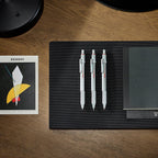 3 Rotring 600 3-in-1 Multi Pen with Mechanical Pencil in Silver on a black sheet with notebook