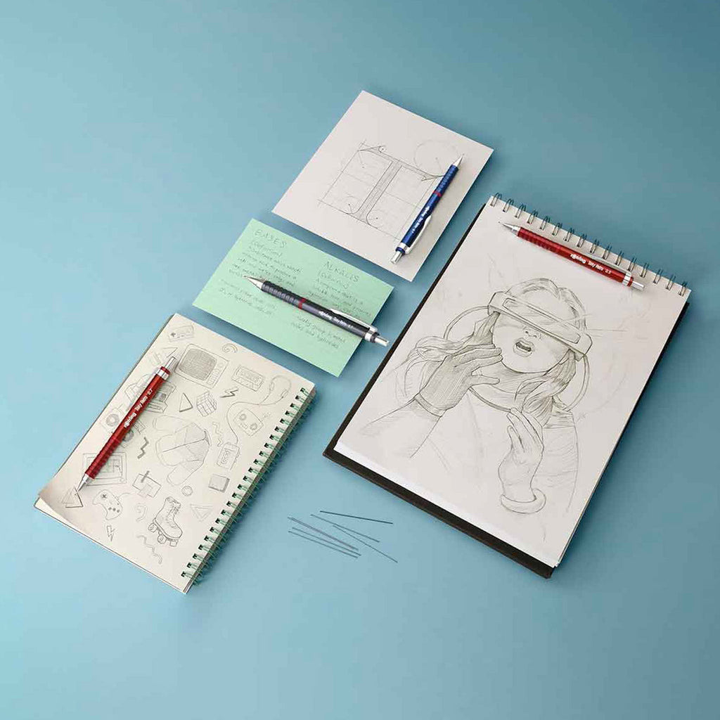 Drawings on spiral-bound notebooks with Rotring Tikky Retro 0.7mm Mechanical Pencil in Metallic Blue on a blue background