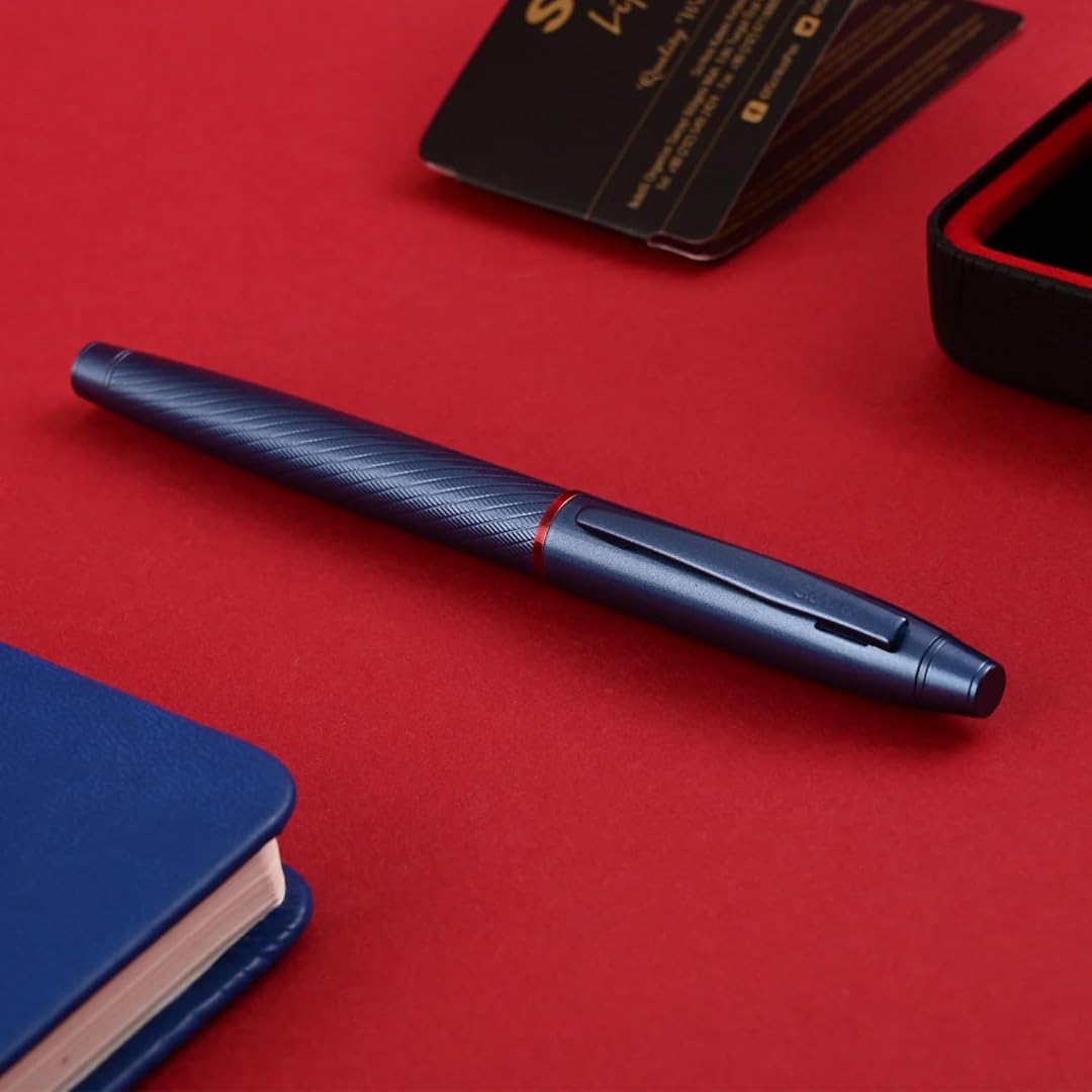Scrikss Noble 35 Medium nib Fountain Pen in Blue on a red surface