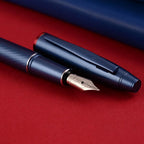 Scrikss Noble 35 Medium nib Blue Fountain Pen on a red surface