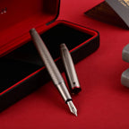 Scrikss Noble 35 Medium nib Fountain Pen in Matte Titanium on a red and black open box