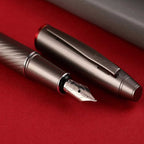 scrikss noble 35 medium nib Fountain pen with detailed design on a red surface