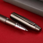 Scrikss Noble 35 Rollerball Pen in Matte Titanium on a red surface showing pen and pen cap side by side