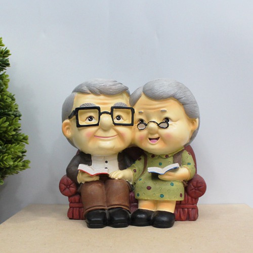 Cute Old Couple with Piggy Bank
