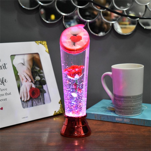 Beauty and the beast eternal rose flower floating in a snow glass bottle with multicolored LED lighting for this Valentines Day