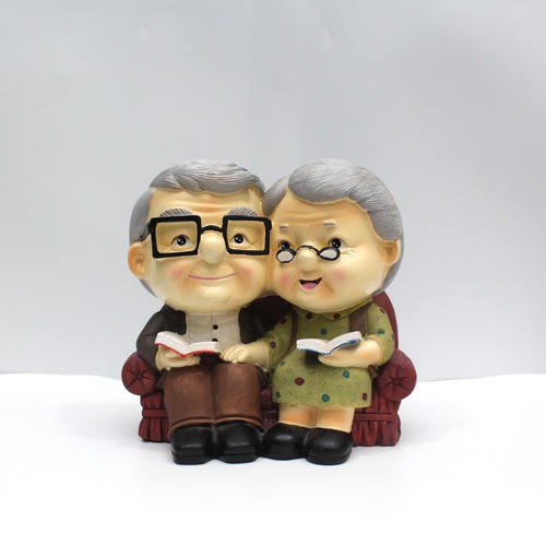 Cute Old Couple with Piggy Bank